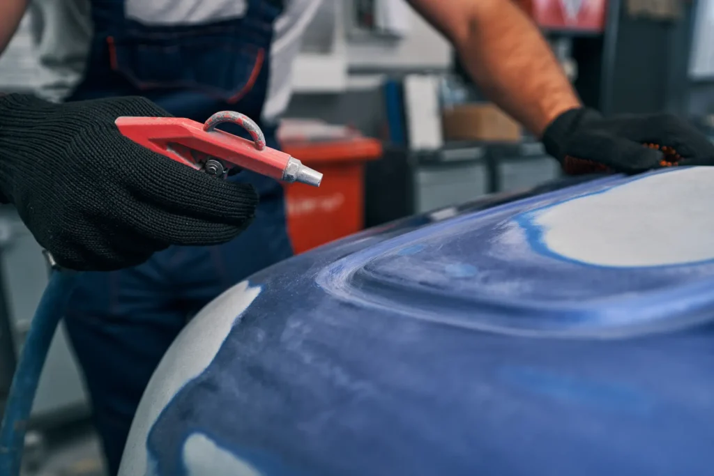 air blow gun in hand on auto mechanic at work 2025 03 09 22 33 20 utc