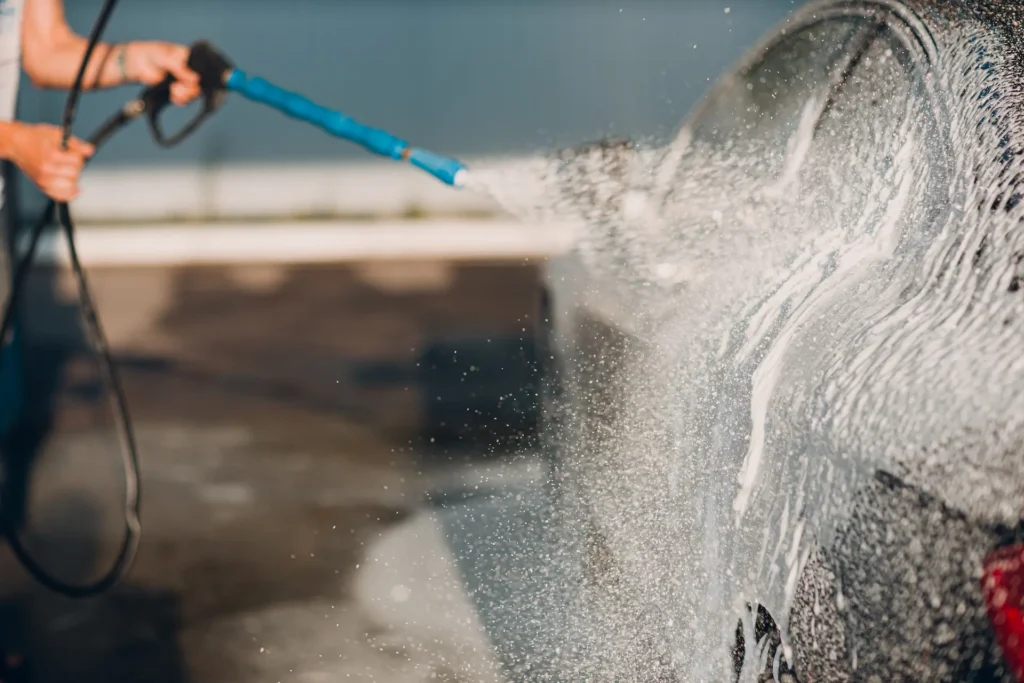 worker washing car at self service car wash 2024 12 04 16 52 09 utc